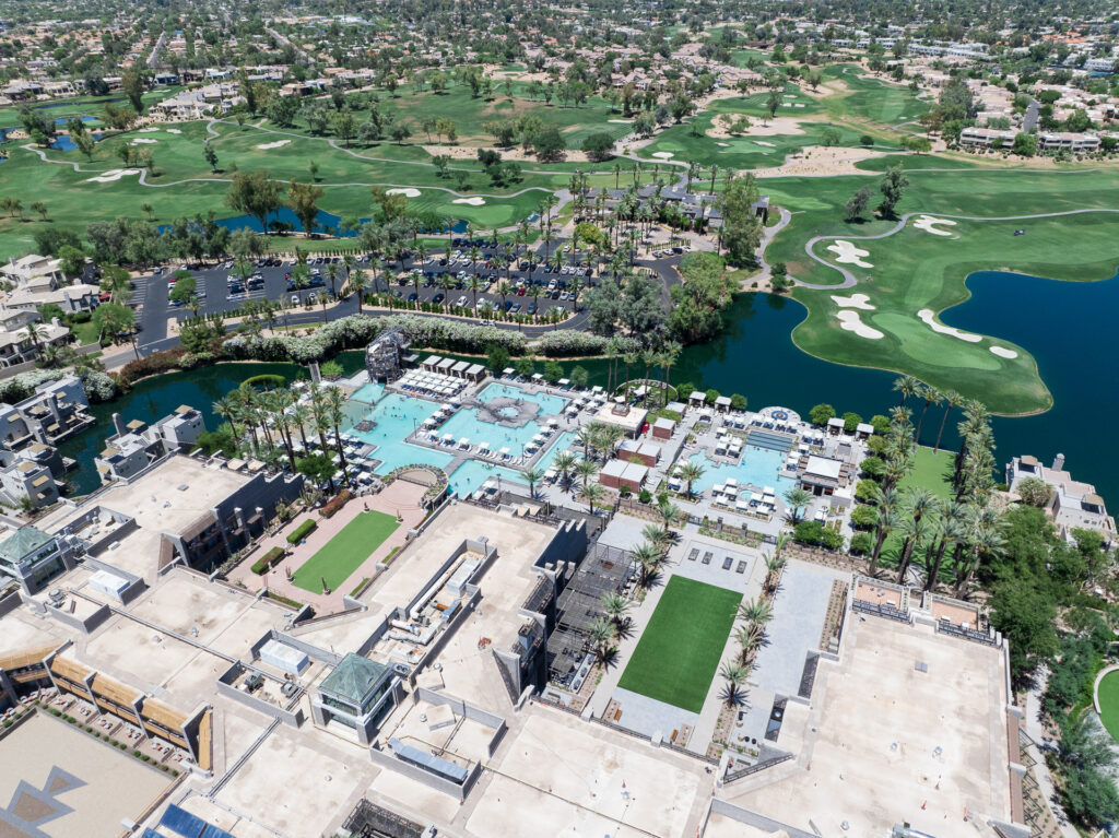 Drone shot of the pool areas, pond, and golf course of Hyatt Gainey Ranch Scottsdale