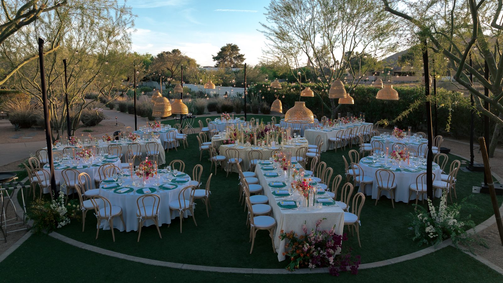 Overhead view of the central curved table and floral installation at an Andaz Scottsdale wedding reception