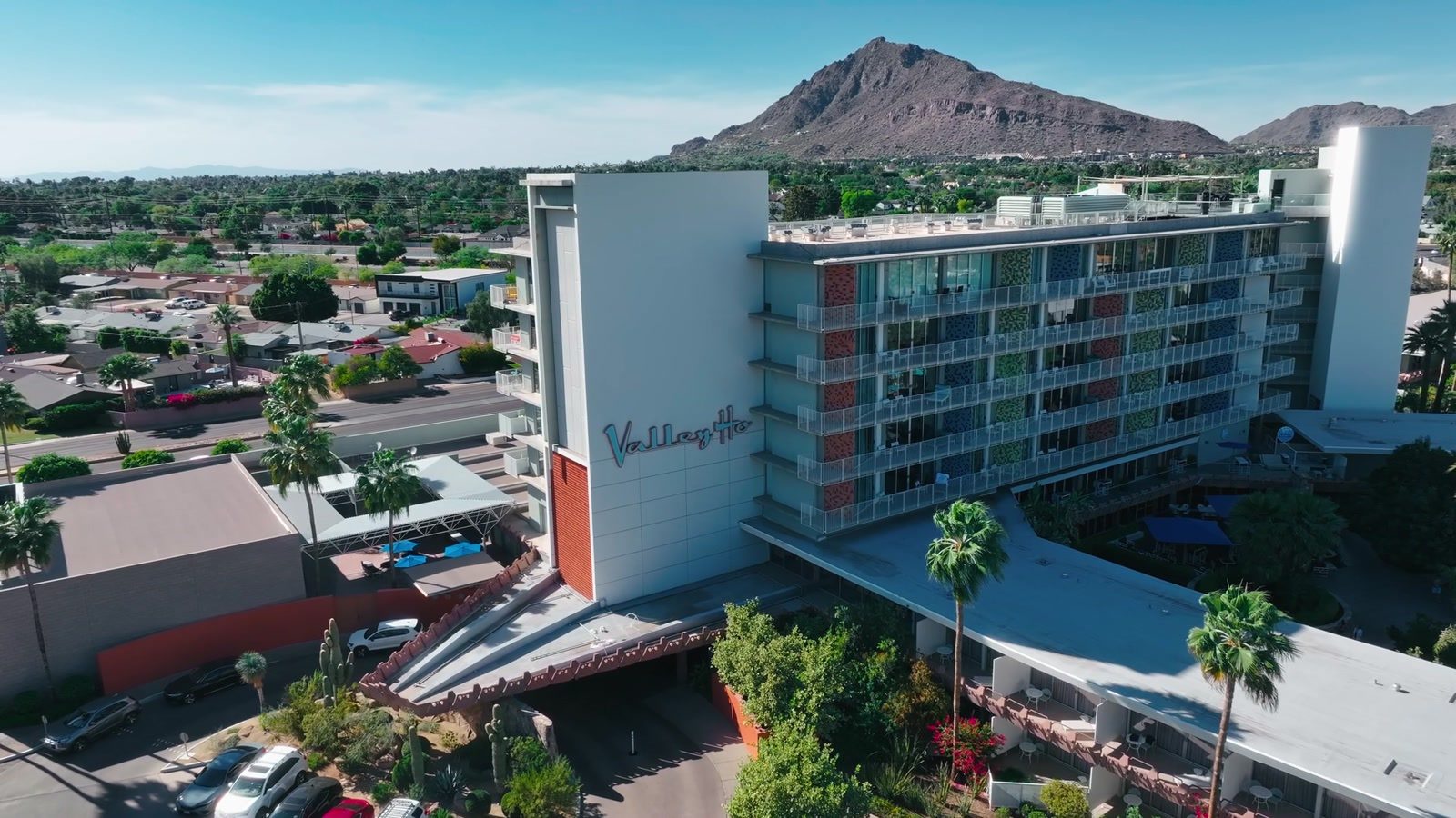 Hotel Valley Ho in Old Town Scottsdale seen from the air, its midcentury script sign on the tower and Camelback Mountain behind